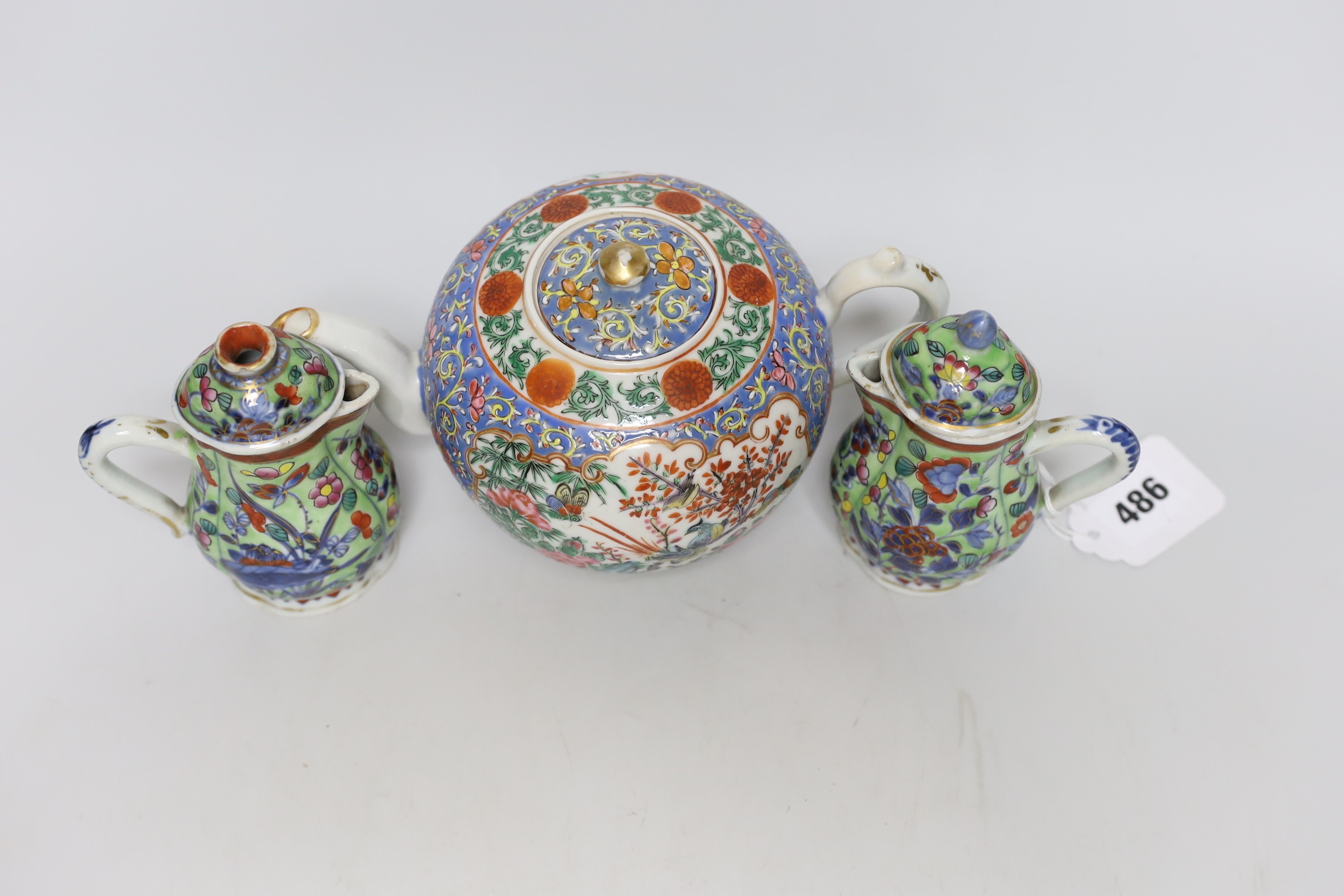 Two Chinese Kangxi clobbered jugs and covers, and a 19th century famille rose teapot, 13cms high